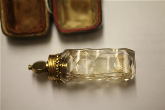 A cased late 18th century gold mounted cut glass miniature scent bottle with stopper and safety chain, approx. 2in.